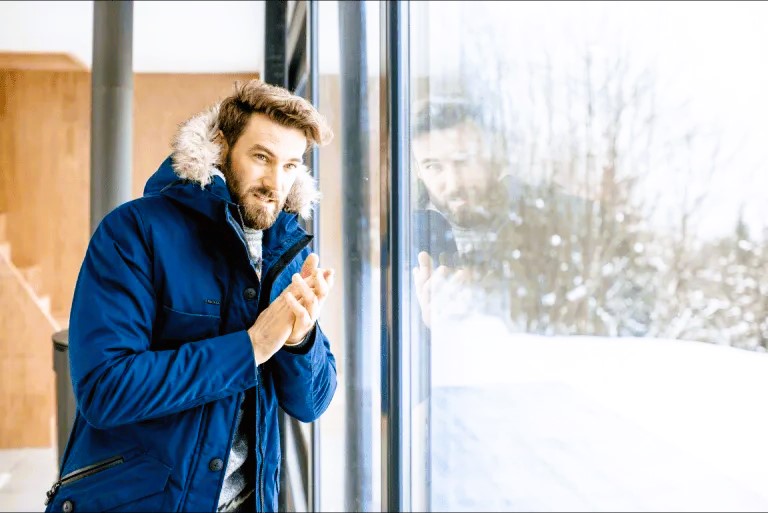 Guy at the panoramic window in winter